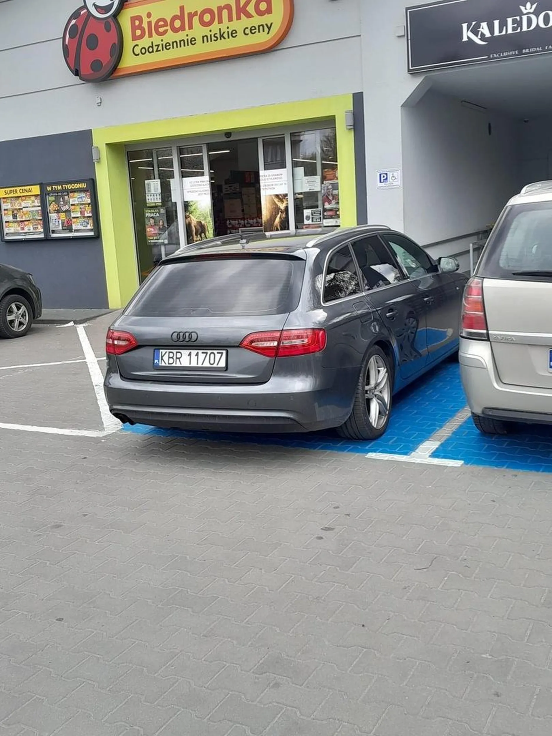 Dzisiejsza sytuacja o godzinie 13.10 pod sklepem Biedronka w Mokrzyskach na ul. Parafialnej 2. Przynajmniej połowa wonego parkingu, przyjeżdżam sobie na zakupy z żoną I synem (dodam że jestem osobą niepełnosprawna po amputacji nogi) i miejsce dla niepełnosprawnych zajęte przez młodego Pana z synem który nie wyglądał Mi na osobę niepełnosprawna (chyba że umyslowo) Ale jak zapytałem Pana czy jest osobą niepełnosprawna ponieważ nie widzę plakietki, to się zmieszał). Pan zaparkował na tym miejsc z lenistwa,  a Ja musiałem o kulach iść przez pół parkingu, do tego musiałem czekać aby auto obok odjechało abym mógł w ogóle wysiąść z auta. Możecie mnie hejtowac ale uważam że należy mieć trochę honoru i przejść kilka kroków.