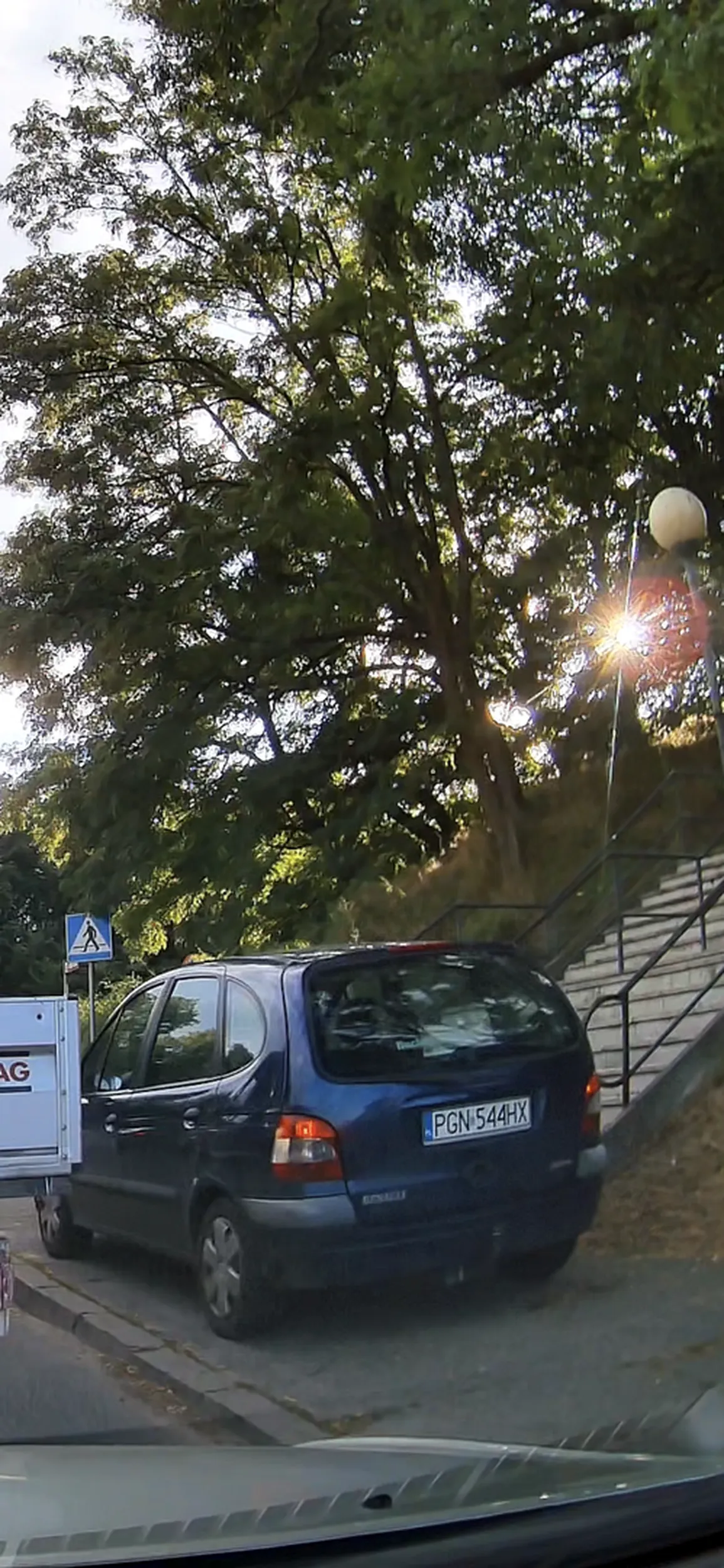 Koleś wyprzedza kolejke .... chodnikiem, przy ktorym są schody z cmentarza, pasy