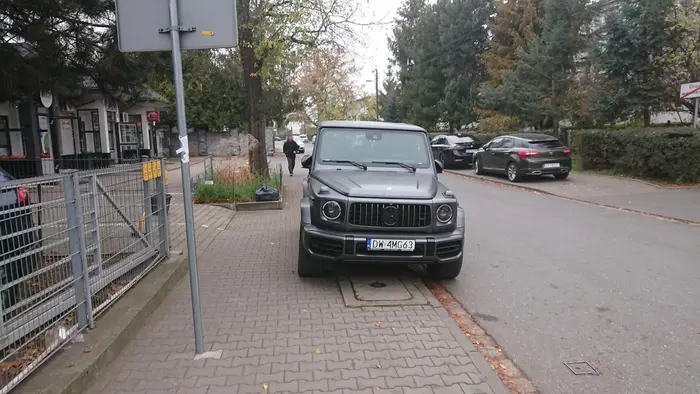 Na chodniku, na zakazie, blokując wjazd na parking. Zamiast rejestracji AMG proponuję kupić sobie Prawo o ruchu drogowym i poczytać.
