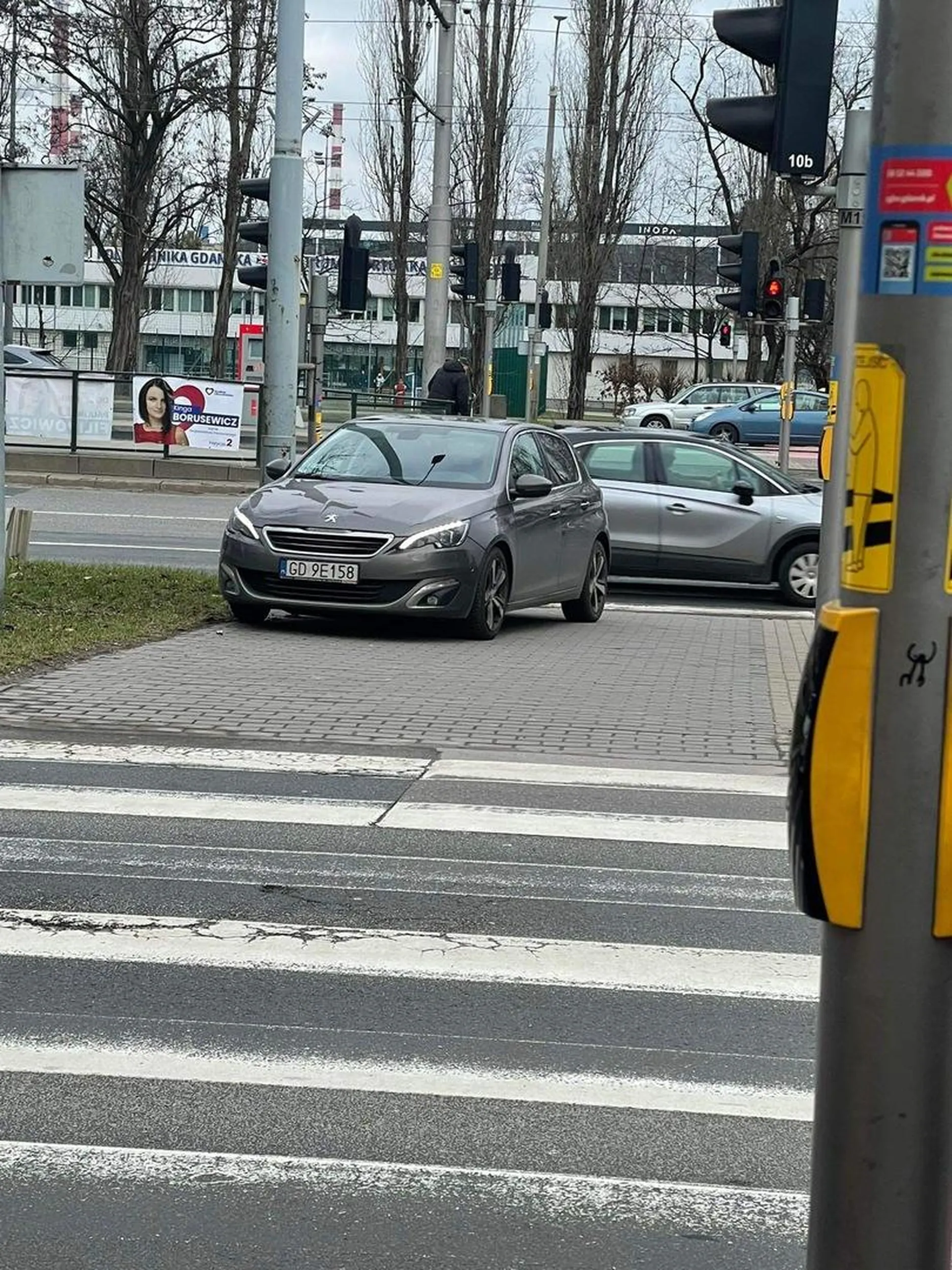 szalona kobieta stoi na srodku chodnika i napastuje przechodniów