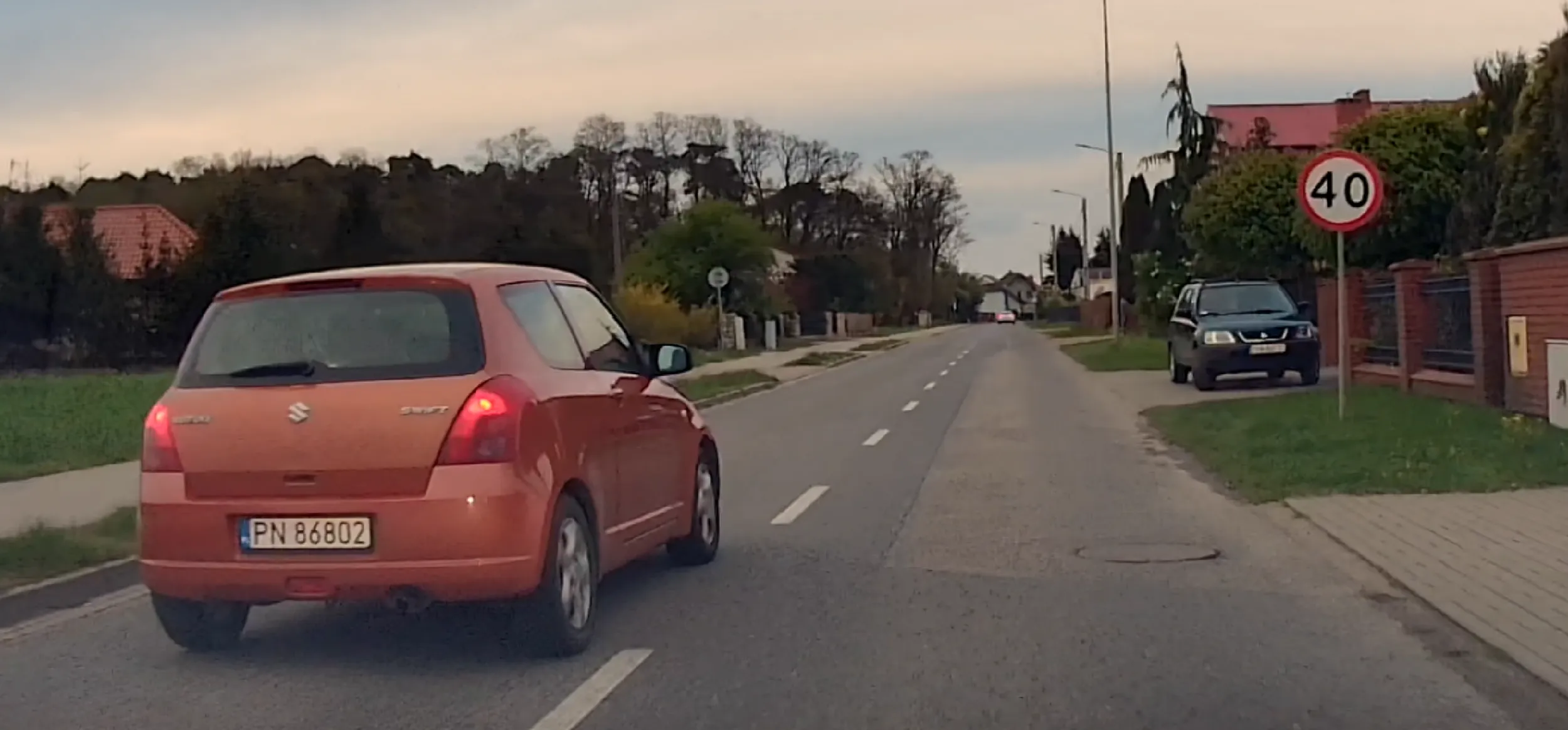 Wyprzedzanie 90 przy ograniczeniu 40, przekraczanie limitu o 60+ km/h. Kobieta blond włosy, pomarańczowe Suzuki Swift