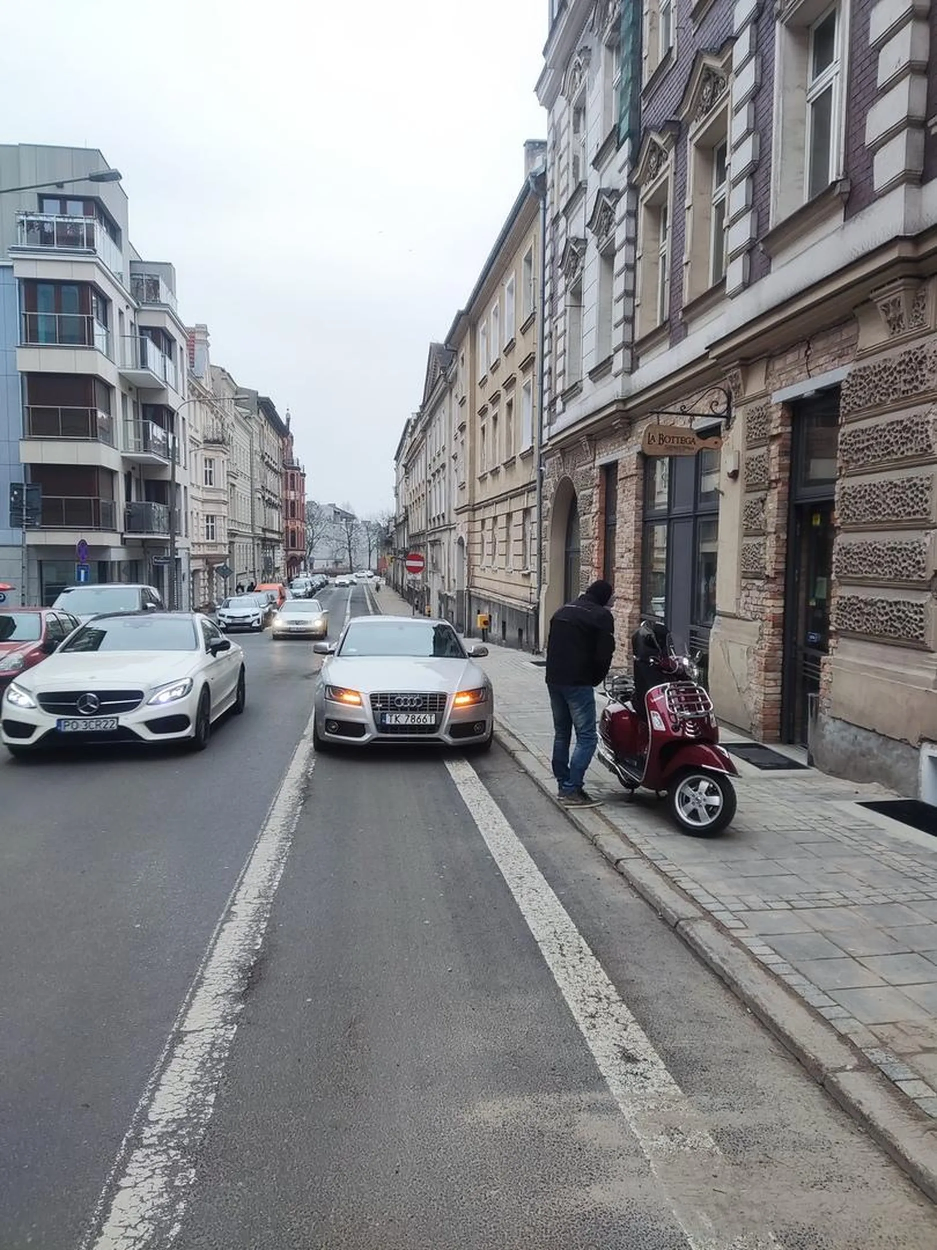 Blokuje przejazd rowerowy na wąskiej drodze.