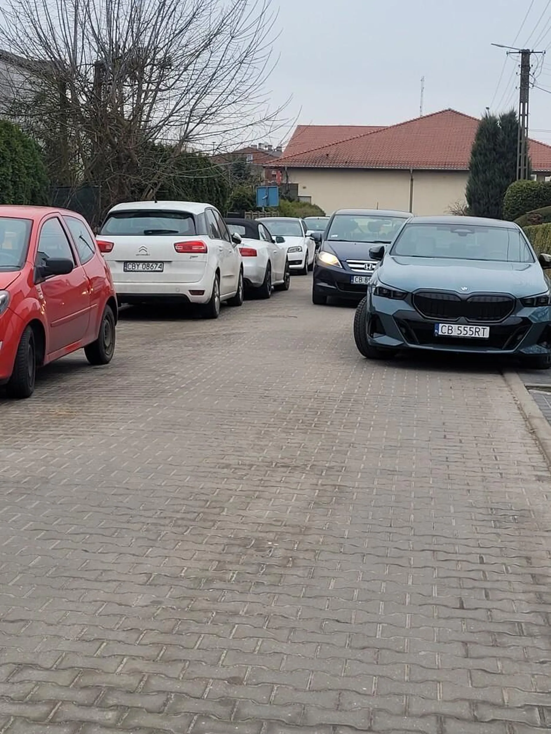 Kierowca parkuje  jak chce  pod domem. ,tworzy się  czasem kolejka kierowców  chcących  przejechać.  Totalny brak wyobraźni