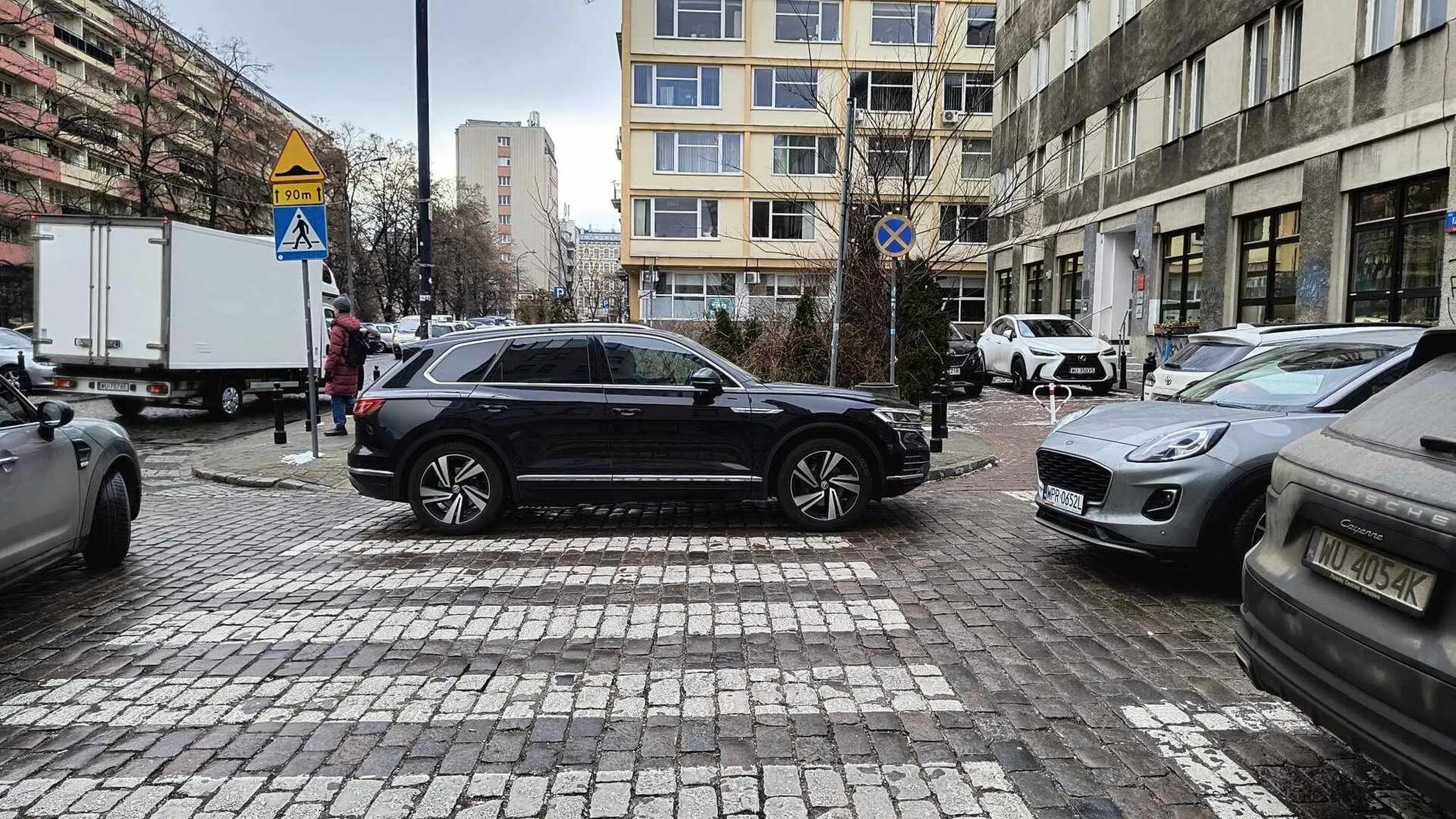 burak stoi swoim złomem blokując przejście dla pieszych, samemu rozmawiając przez telefon