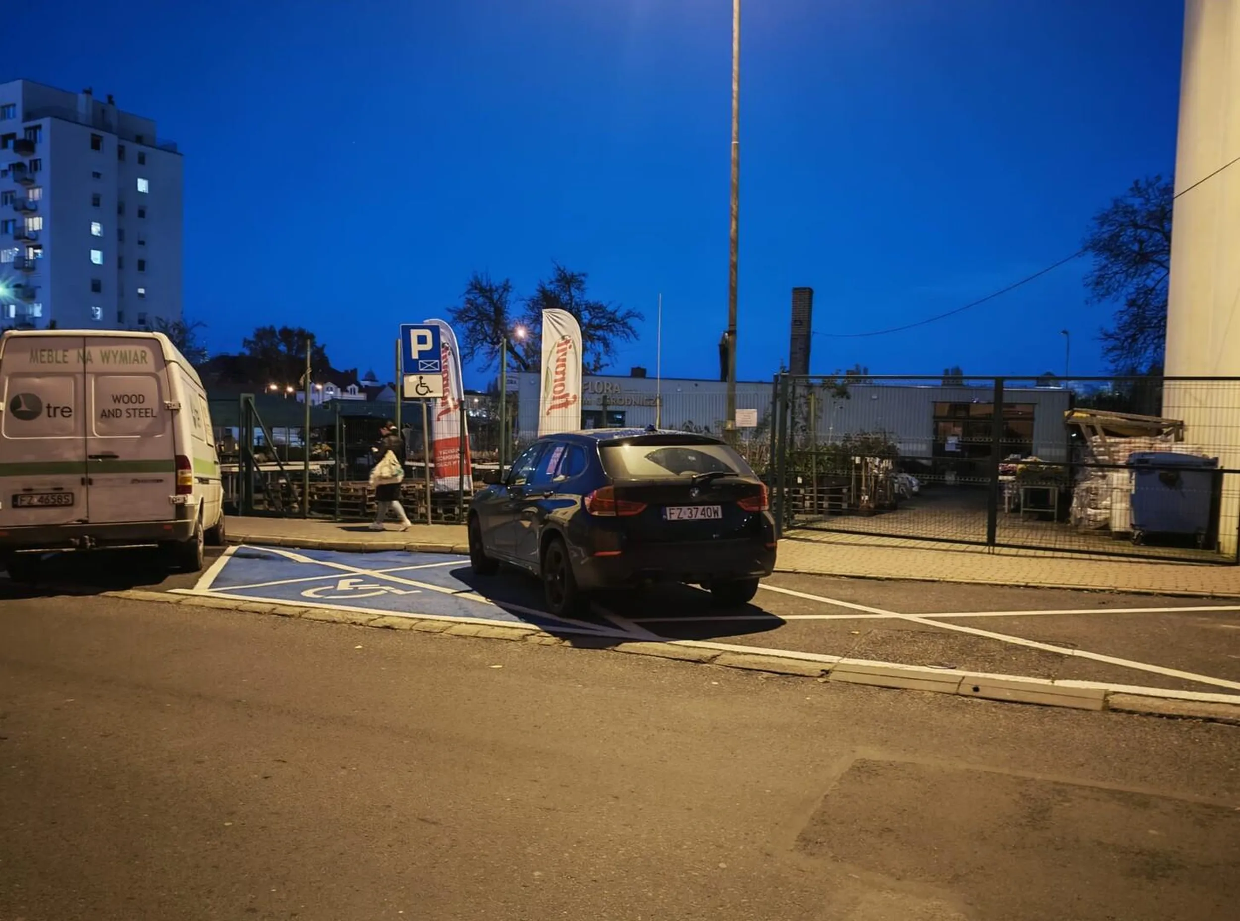 Kierowca nie może się zdecydować czy bardziej blokować bramę czy miejsce dla niepełnosprawnych (karty oczywiście brak).