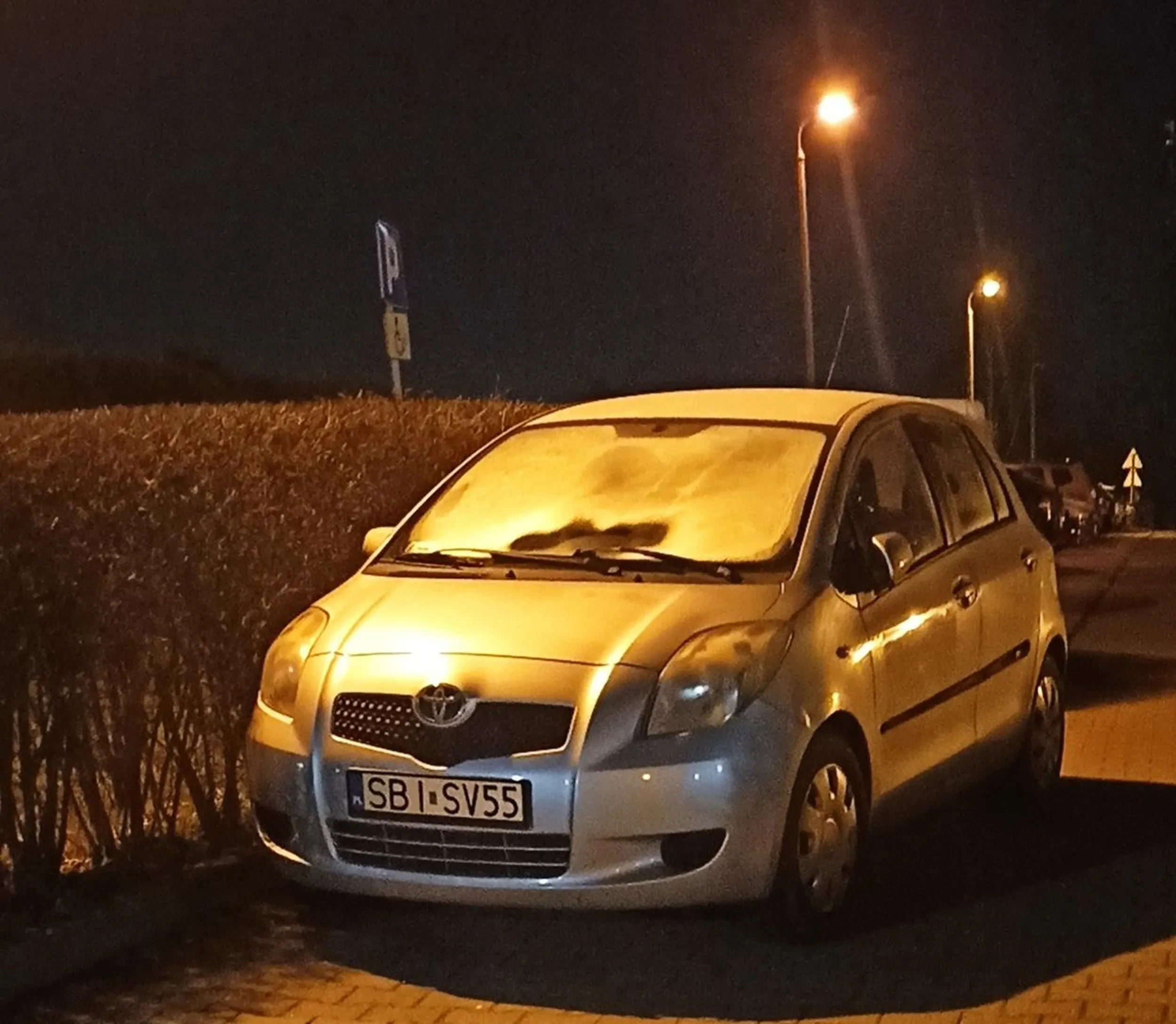parkuje samochód przy wjeździe na parking, blokując w ten sposób wjazd.