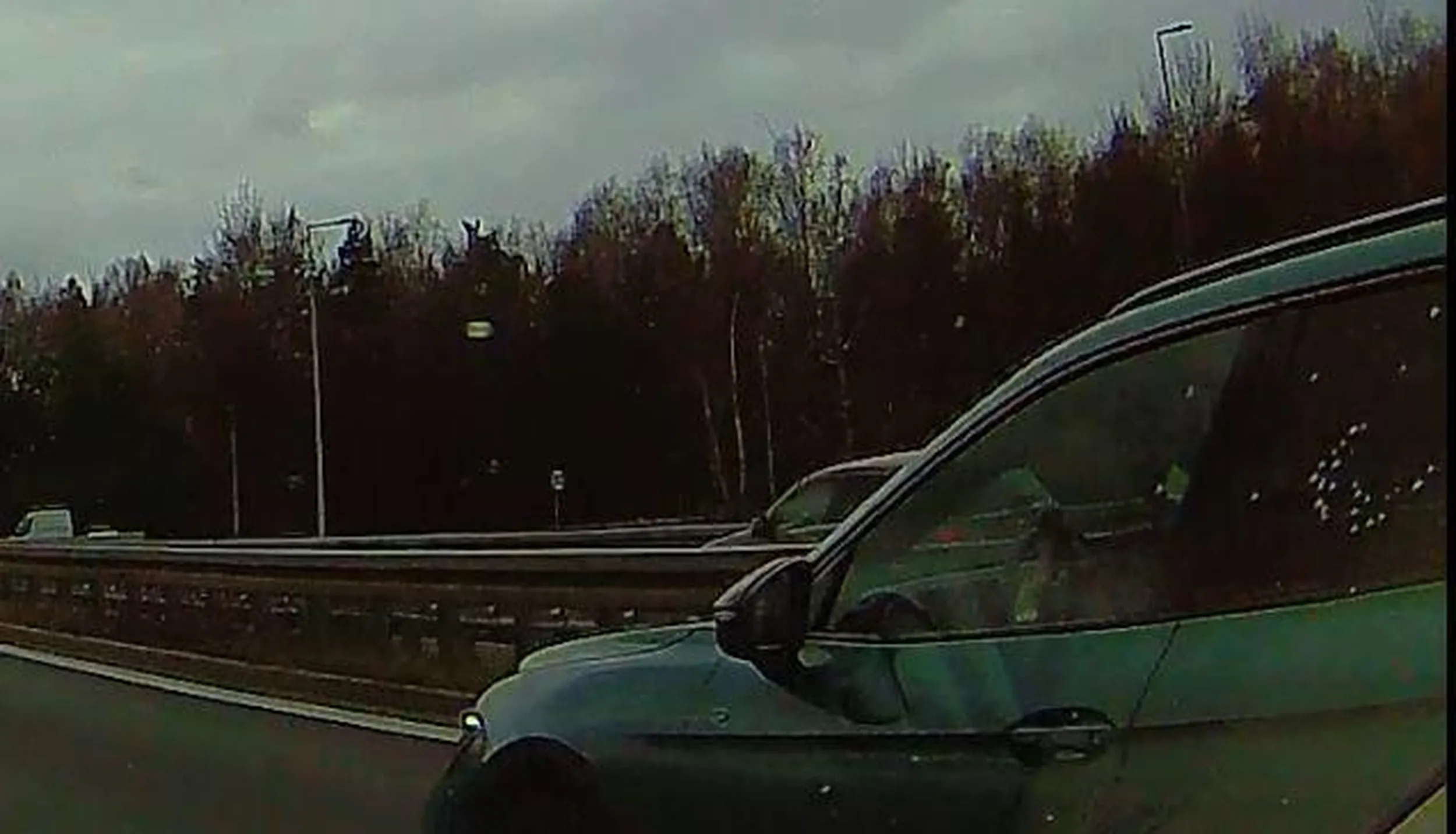 Fantastyczny kierowca. xD Obie ręce oparte o kierownicę przedramionami i nadgarstkami. W obu dłoniach trzymany telefon, w którym jest grzebane podczas jazdy tak trzymaną kierownicą.