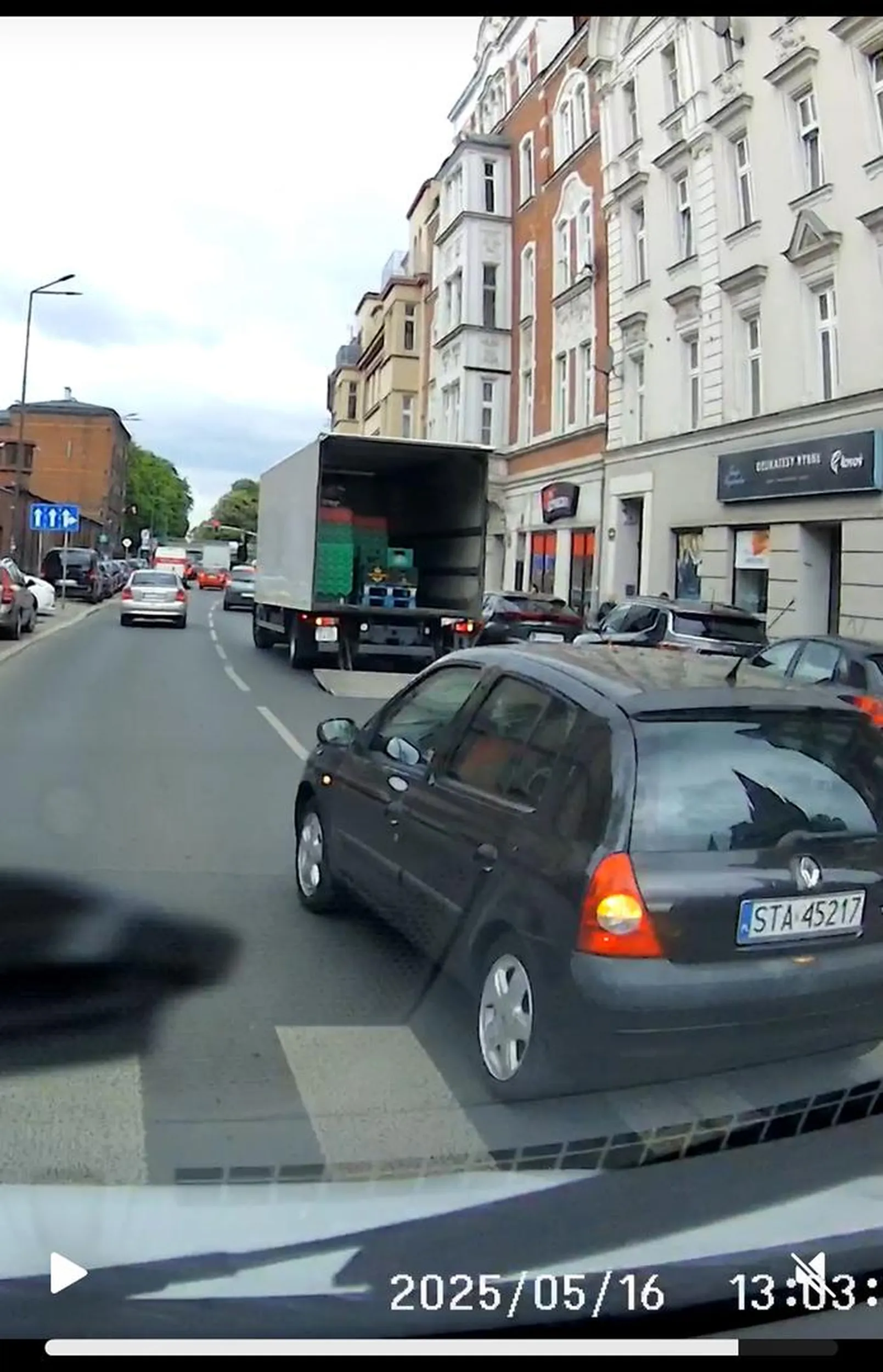 Bytom. Dzisiaj. Samochód którym się poruszam to dostawczy Ford Transit. Kamera jest umieszczona bardzo z przodu i wysoko. Widok z kamery nie oddaje tego co widzi kierowca. Samochód który zajechał mi drogę nie był całkowicie widoczny. Widziałem tylko dach i to że porusza się równolegle a napewno nie widziałem sygnalizowania chęci wyprzedzania. Dopiero w ostatniej chwili zorientowałem się że chce mnie wyprzedzić a potem próbuje wymusić wyhamowanie samochodu. Kierowca- kobieta wykonała ten manewr z pełną premedytacją i w typowo chamski sposób. Wyhamowałem w ostatniej chwili, co było trudne bo samochód był załadowany, gdyby nie to to doszłoby do kolizji. Wszystko to na przejściu dla pieszych.