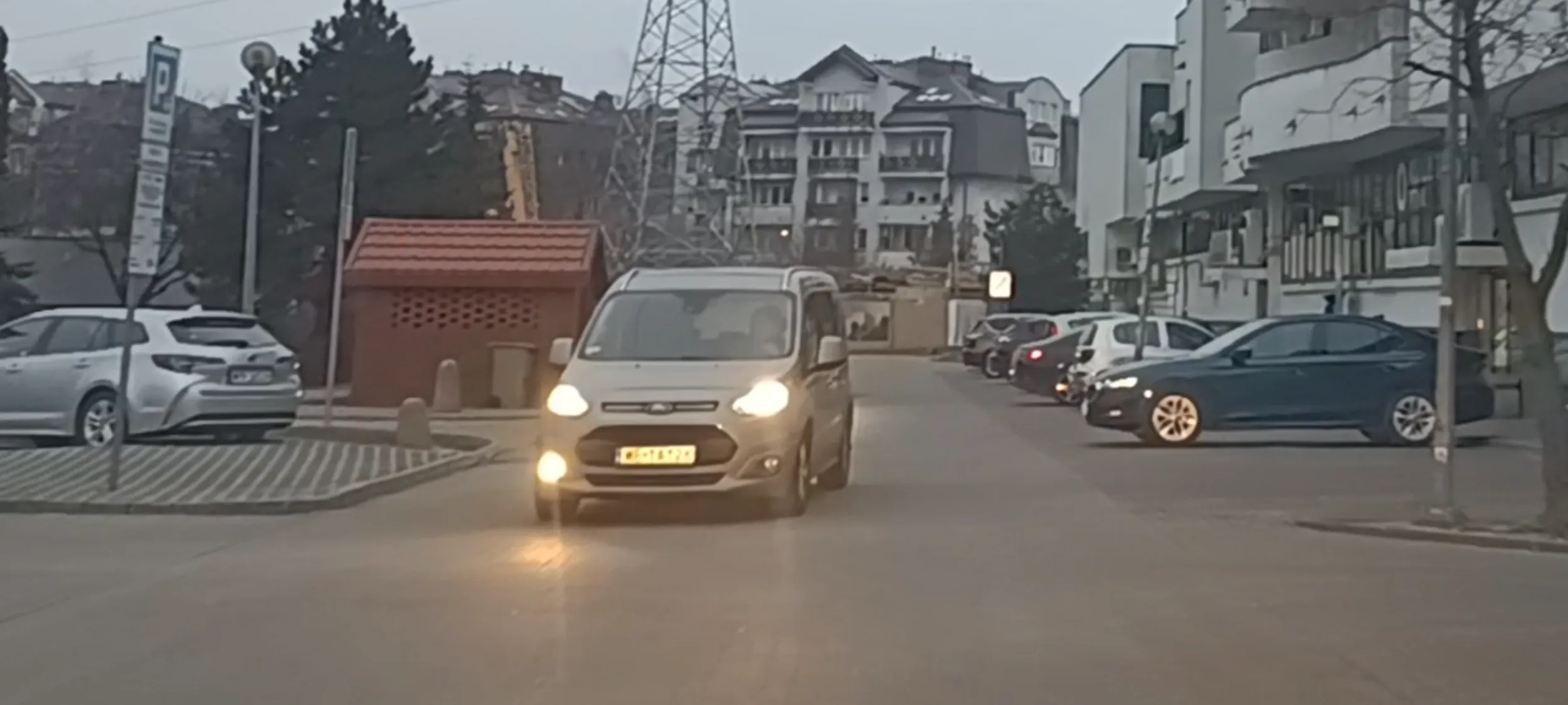 Pierdoła jedzie środkiem parkingu, pewnie pijany jedzie.