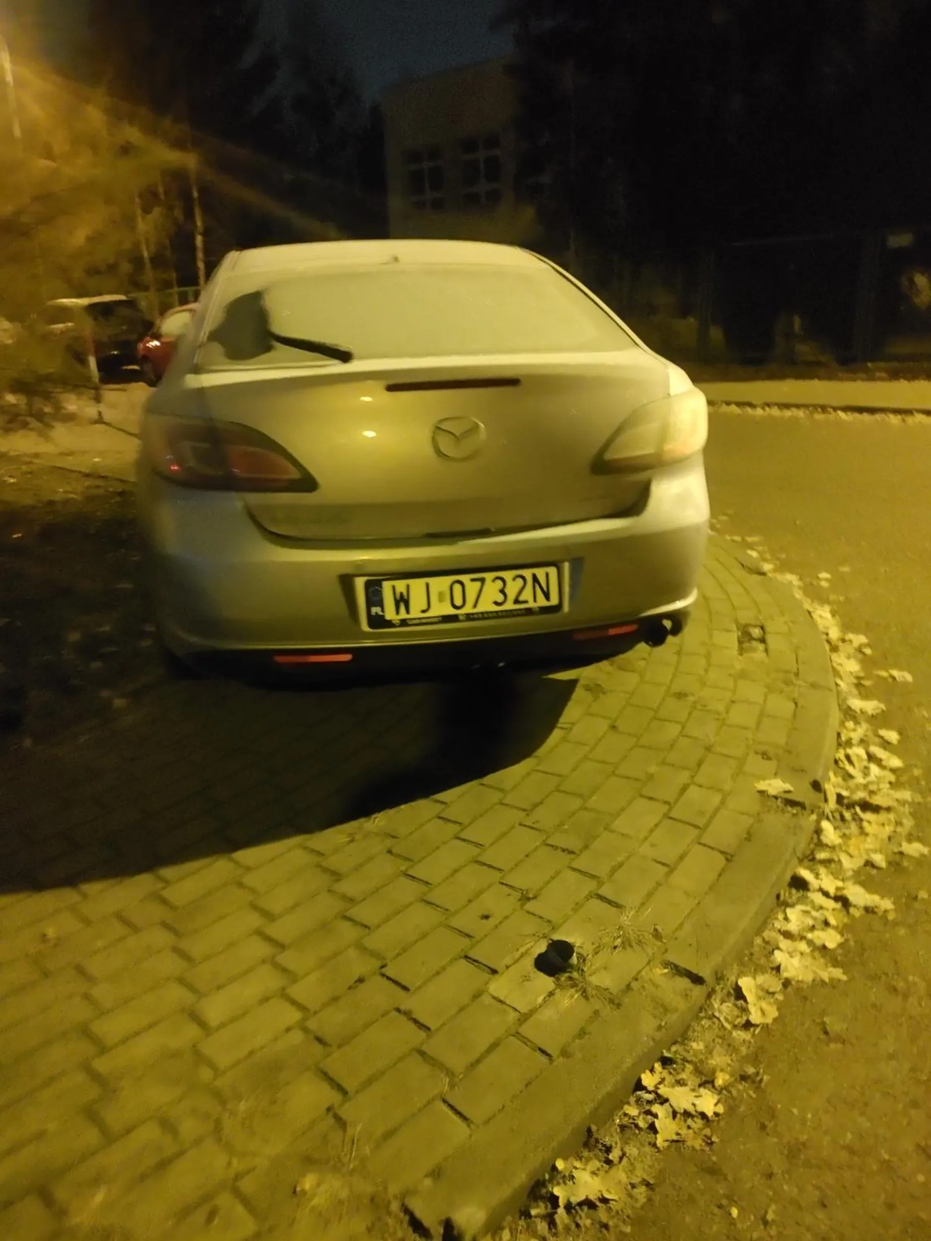 Mały szczyl nawet przy sobocie musi parkować swoją Mazde na chodniku i na zakręcie drogi osiedlowej.