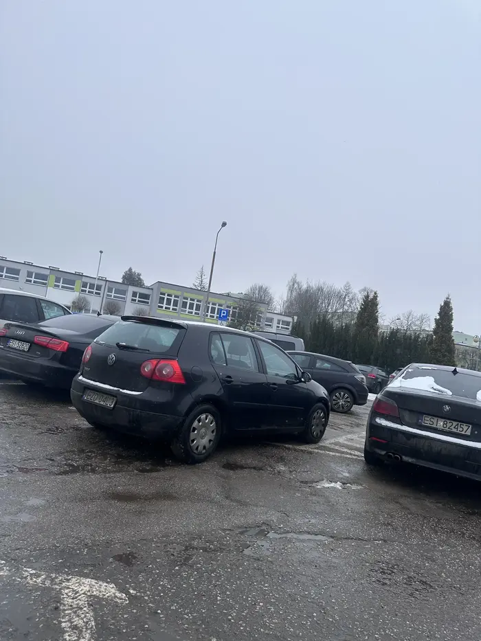 Blokuje przejazd na parkingu.
